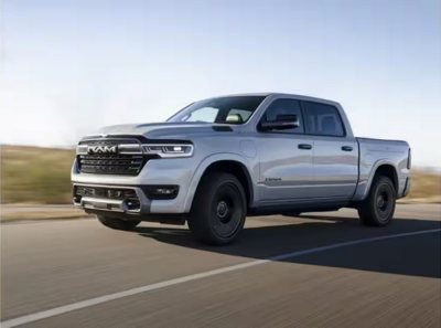 white Ram pickup truck driving on a highway with a scenic background under clear sky