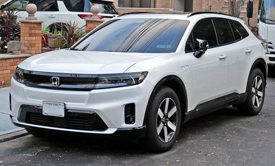 white Honda SUV parked on a street with modern design and black accents around wheels and windows