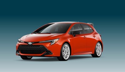 red Toyota hatchback car viewed from the front left side on a gradient blue background