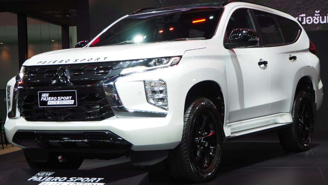 white Mitsubishi Pajero Sport Elite Edition SUV displayed indoors with black grille and black alloy wheels