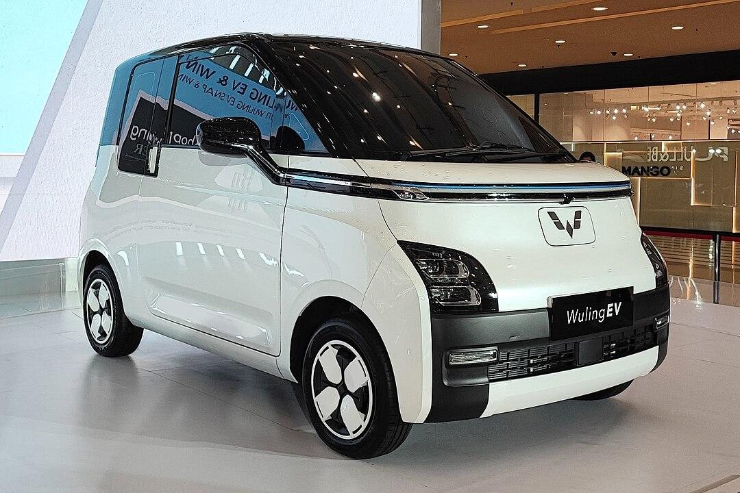 white Wuling EV compact electric car displayed indoors with modern design and black accents