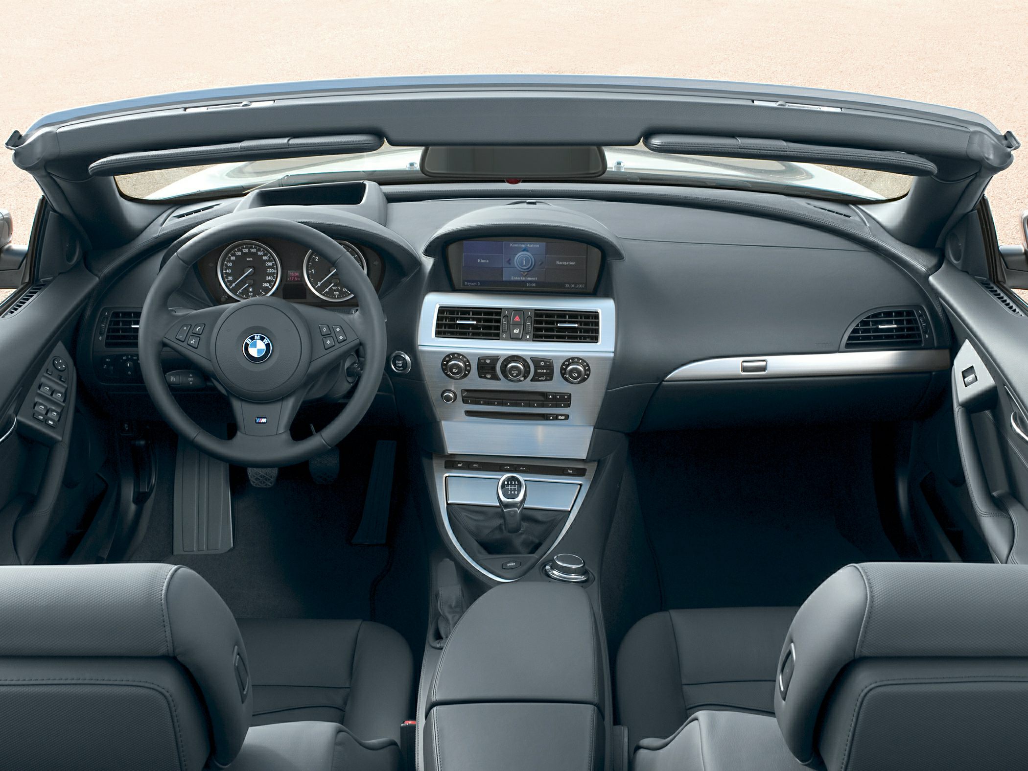 Open-top interior view with manual gear shifter and dashboard controls