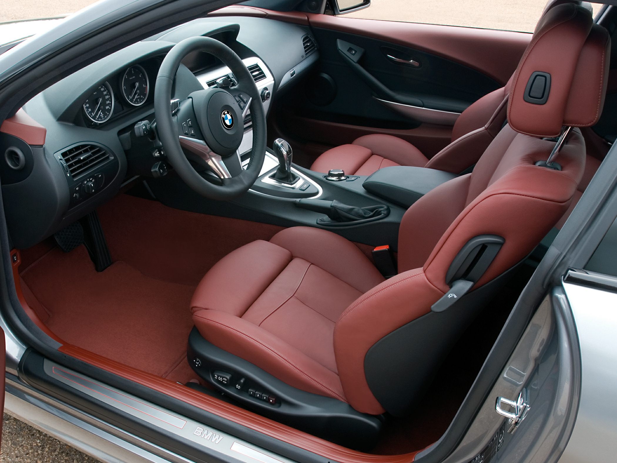 Red leather seats and modern dashboard interior with automatic transmission