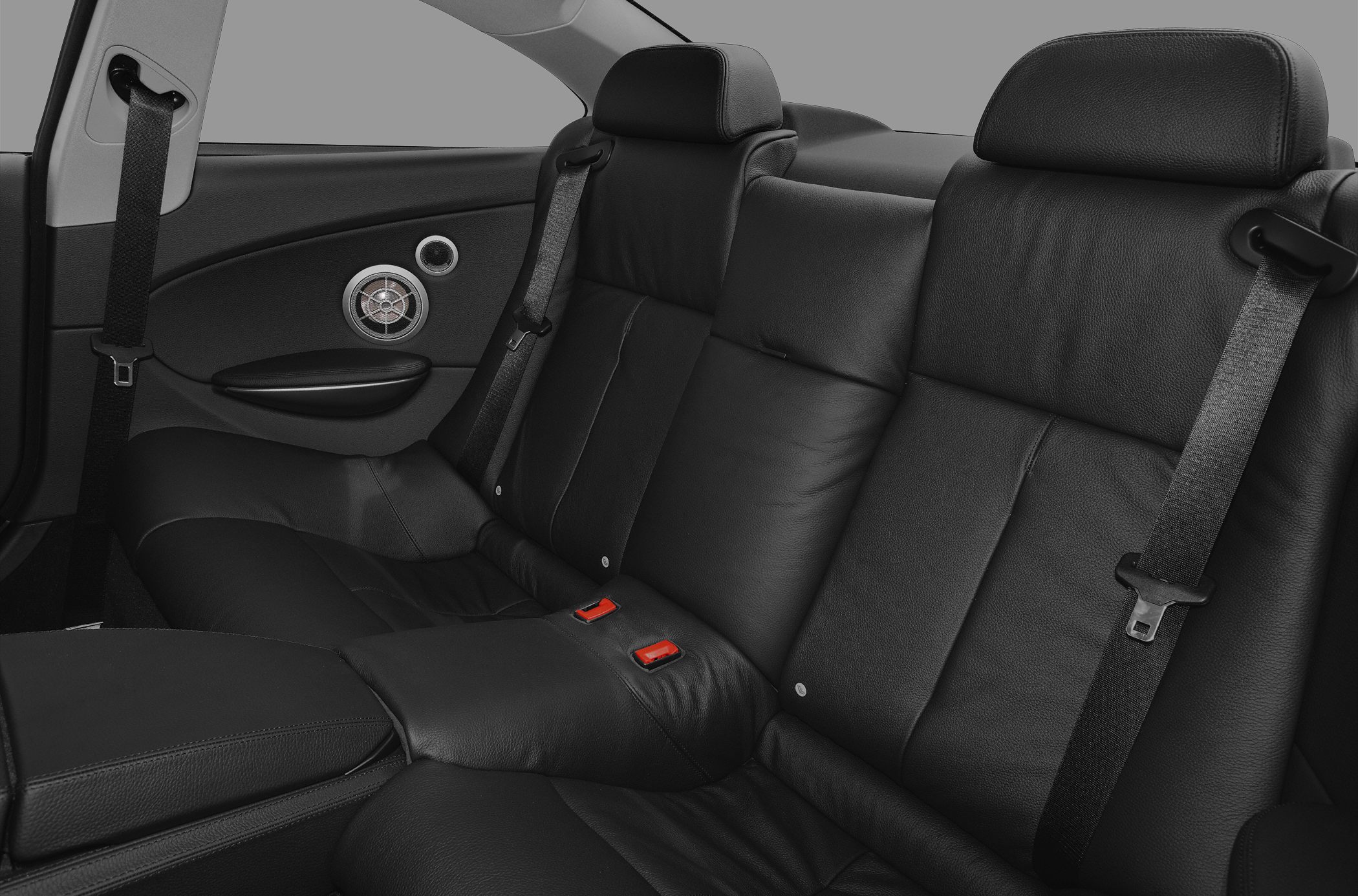 Black leather rear seats with headrests and seatbelts.