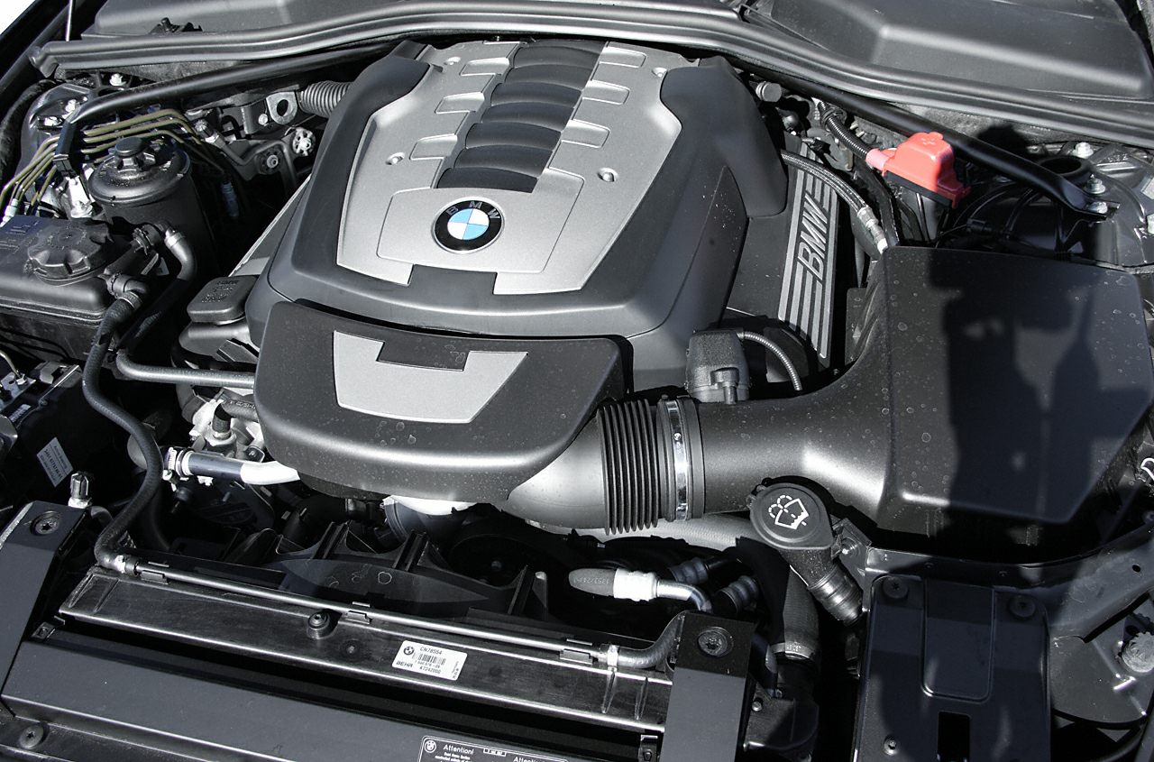 Close-up of BMW engine bay with distinctive engine cover and components