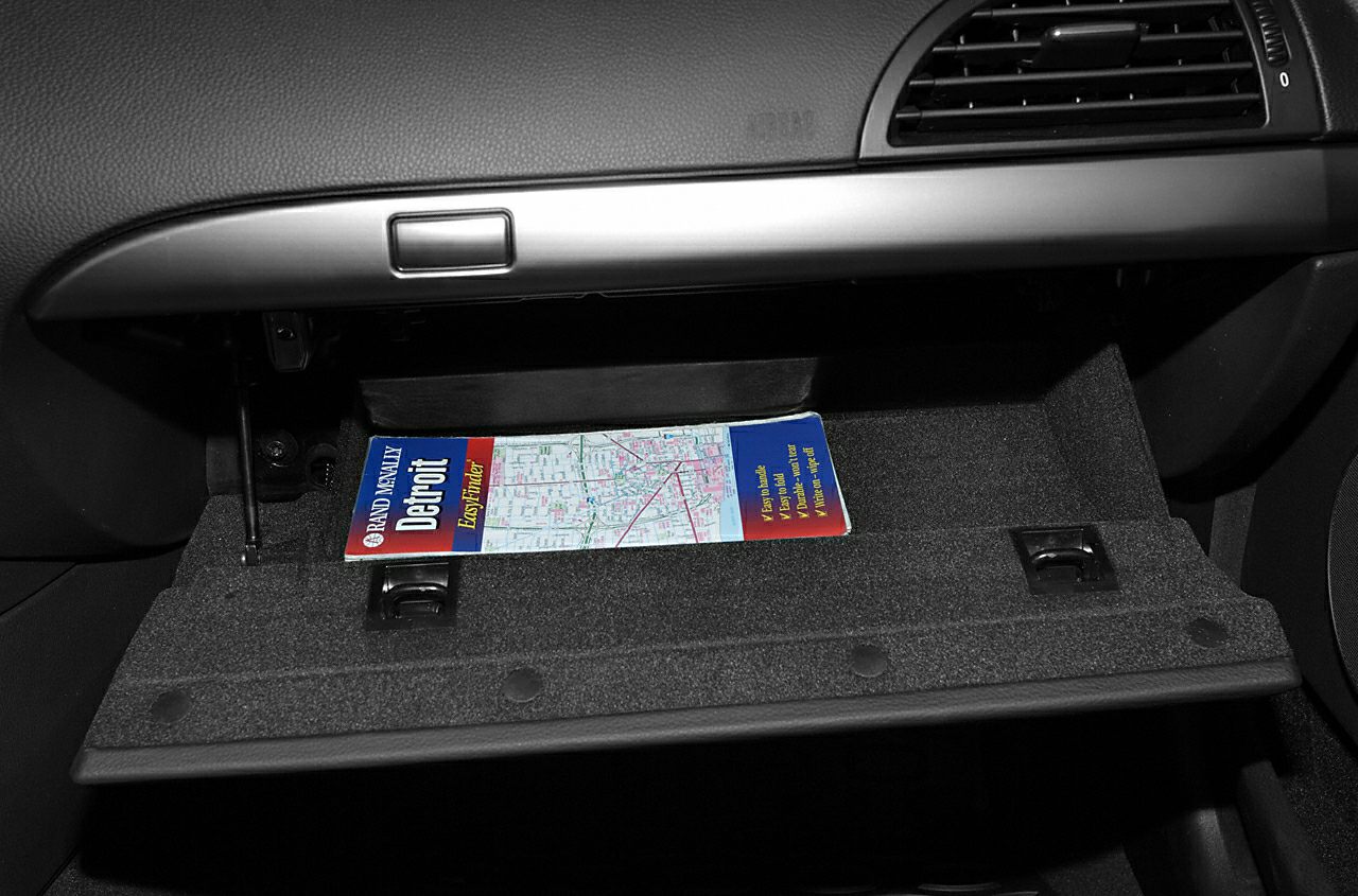 Open glove compartment with a folded map inside