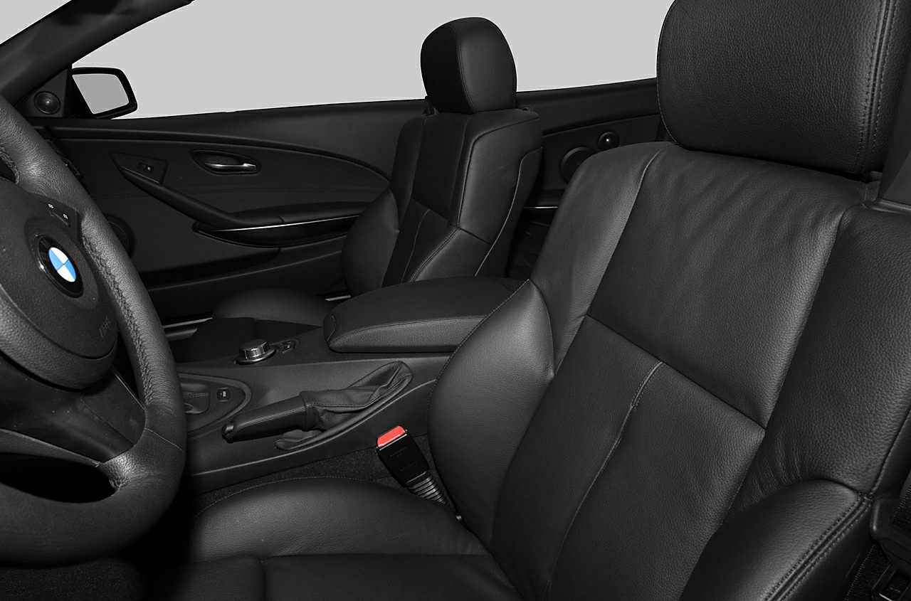 Black leather interior seats with detailed driver controls