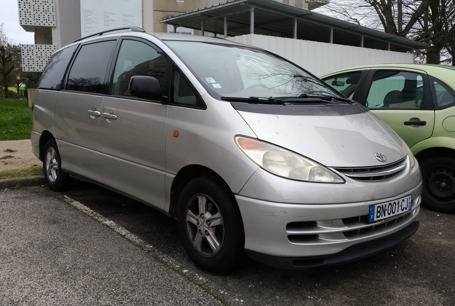 Silver minivan with sliding doors and alloy wheels in side front view