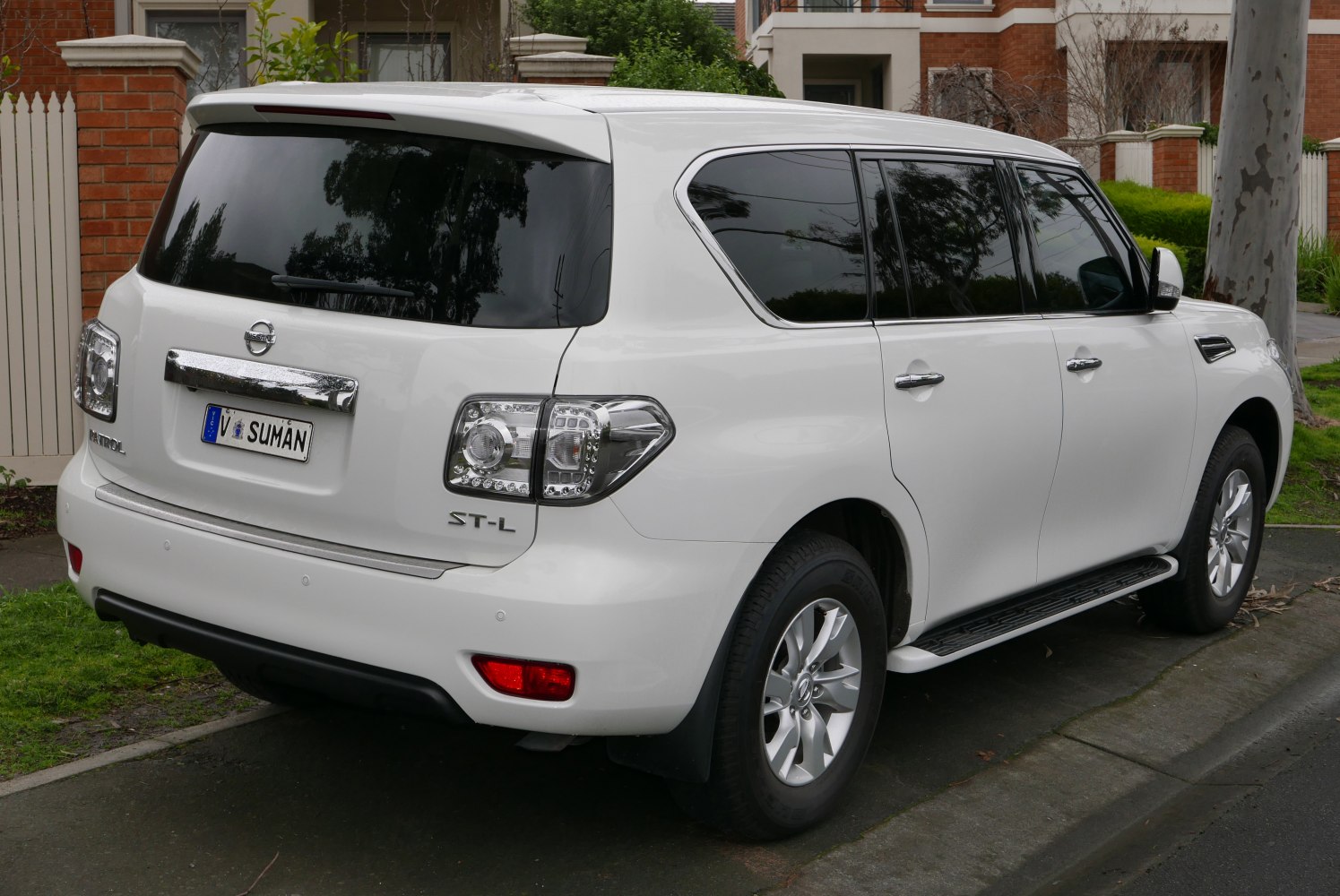 SUV rear right view with tinted windows and side running boards