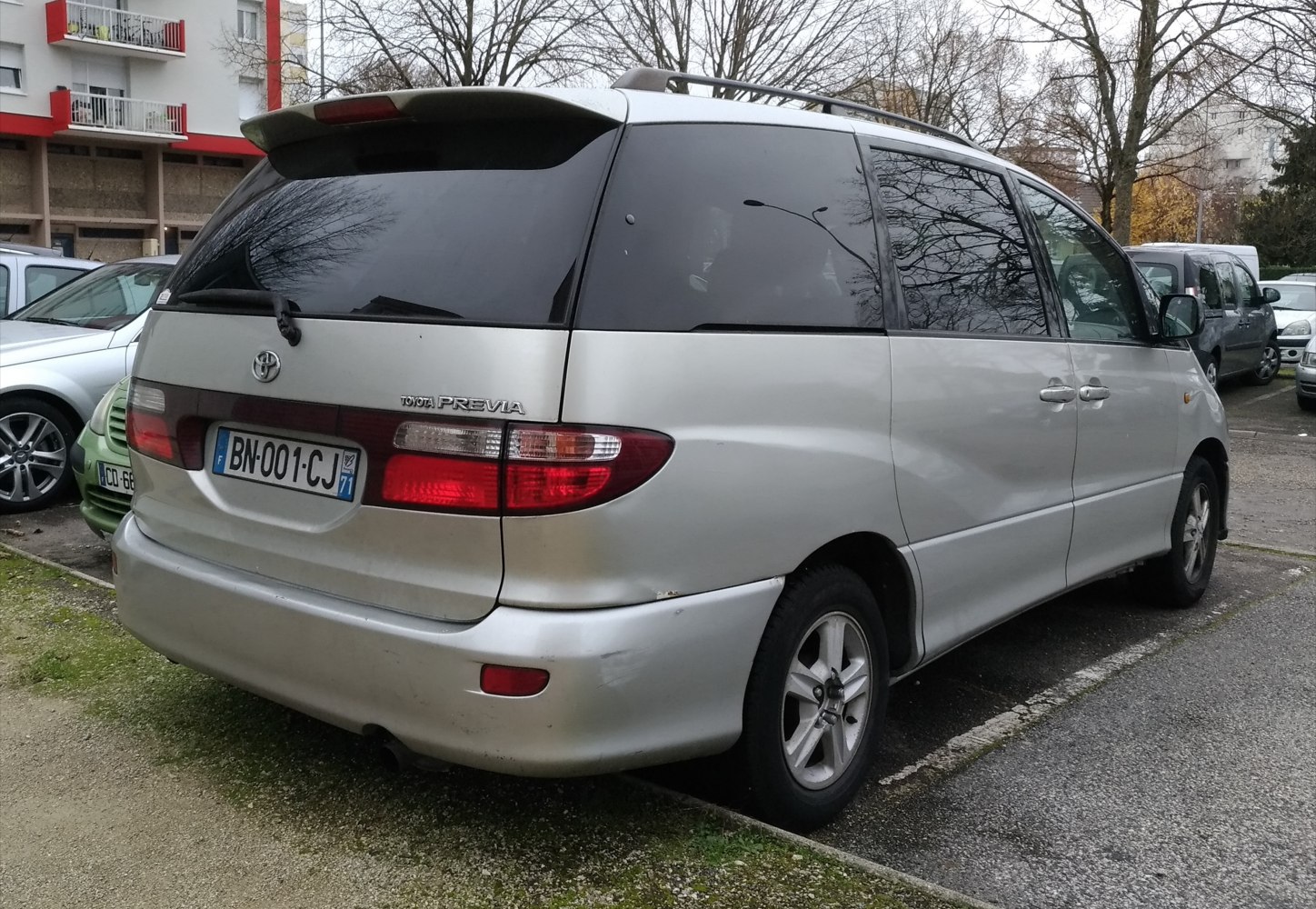 Rear view of minivan with tinted windows and roof rails