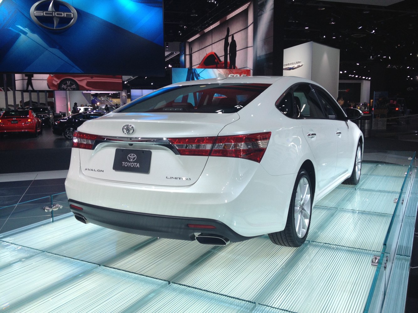 Rear view with elongated tail lights and dual exhausts on a white sedan