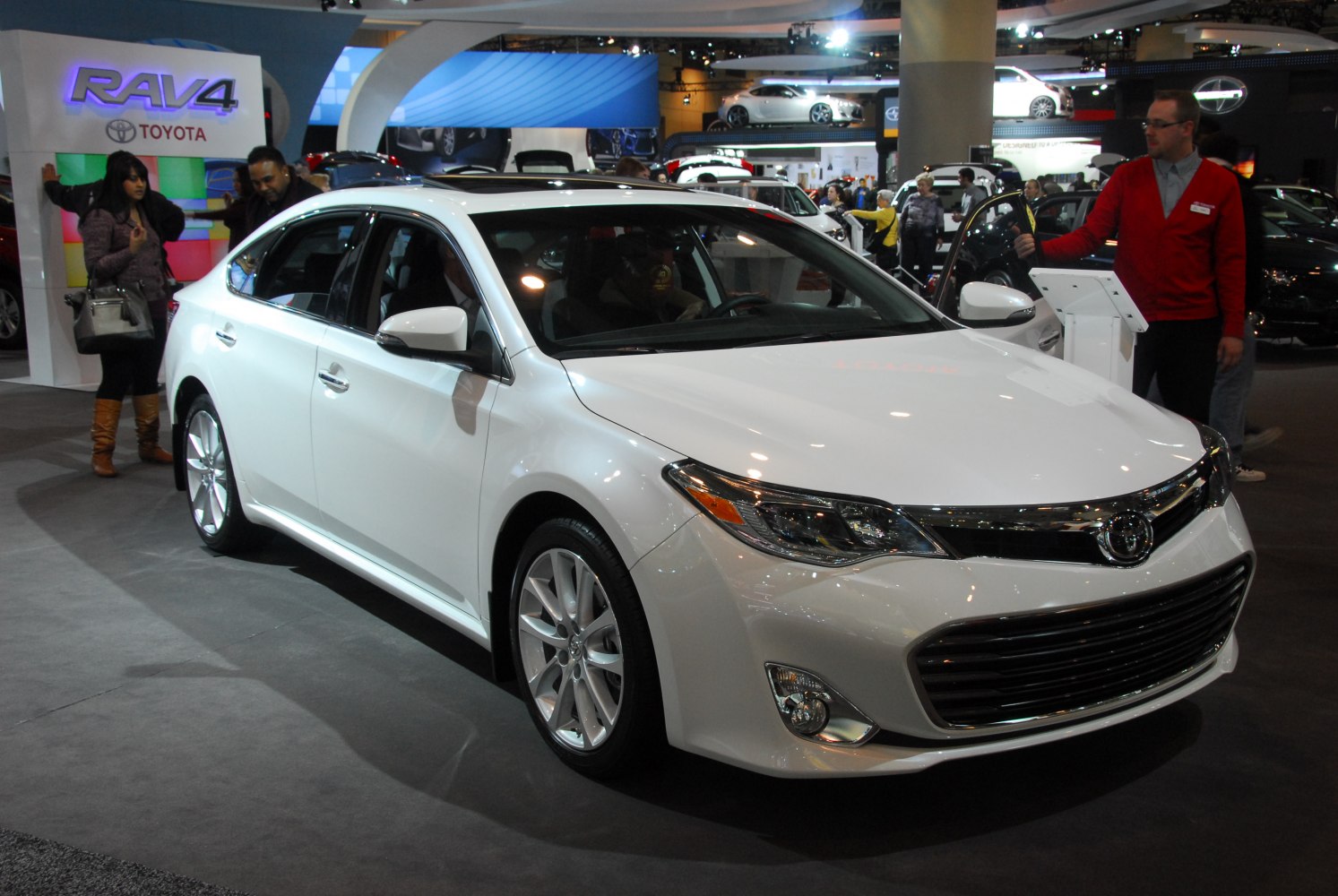 White sedan front side view with chrome grille and sleek headlights