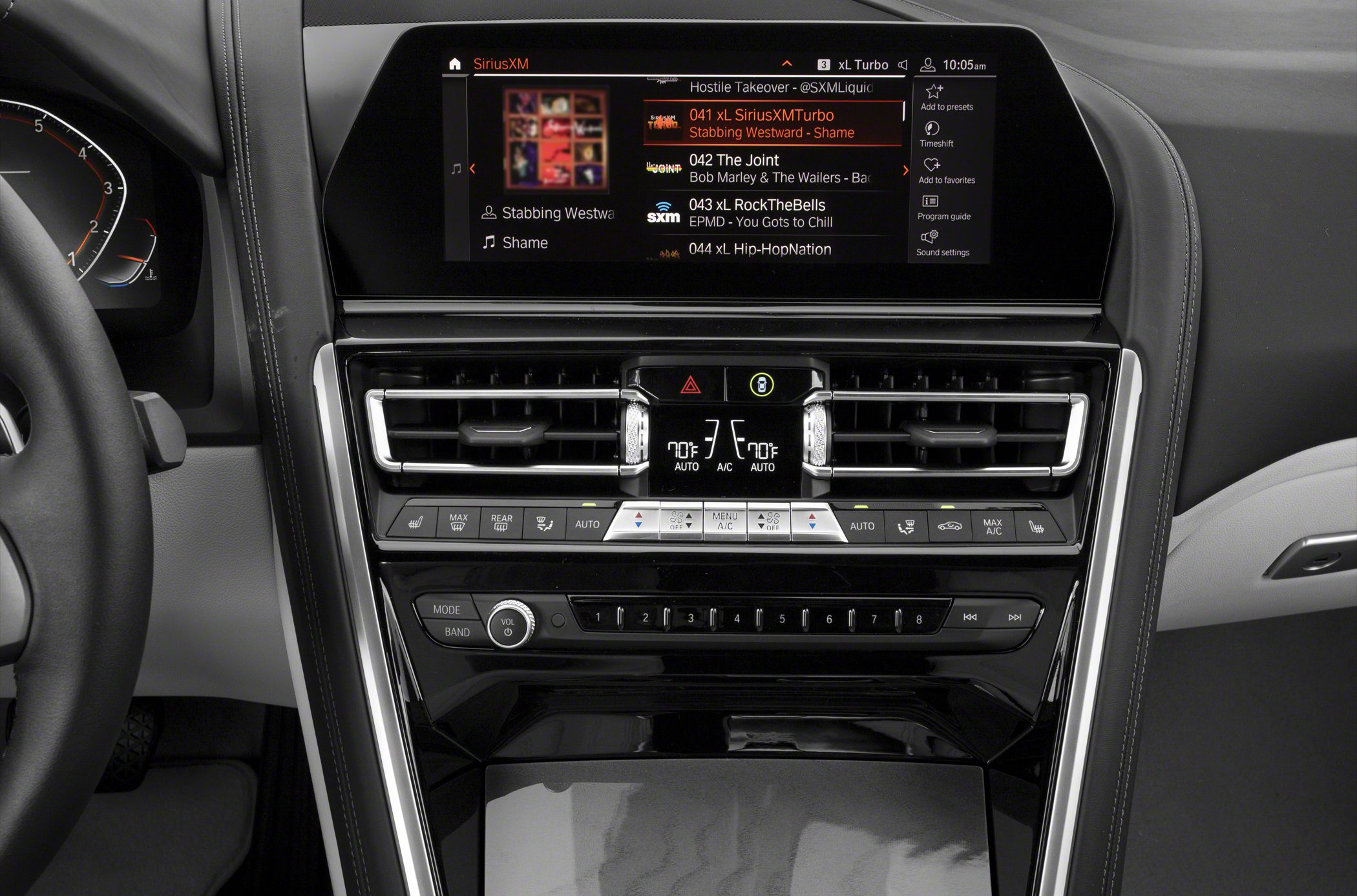 Digital infotainment screen and dual-zone climate control panel with physical buttons and vents