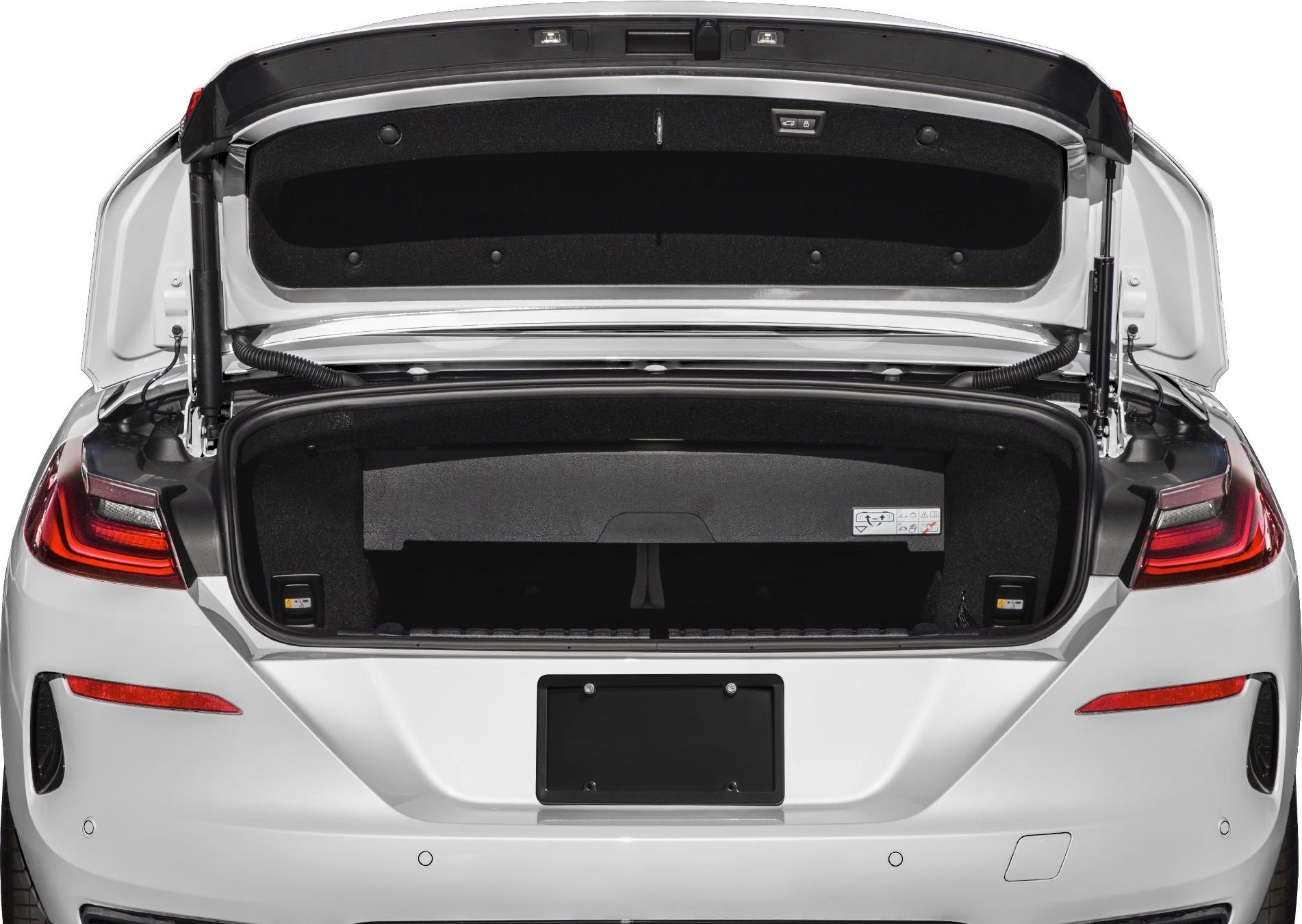 Rear view of an open trunk with taillights and trunk lid support struts