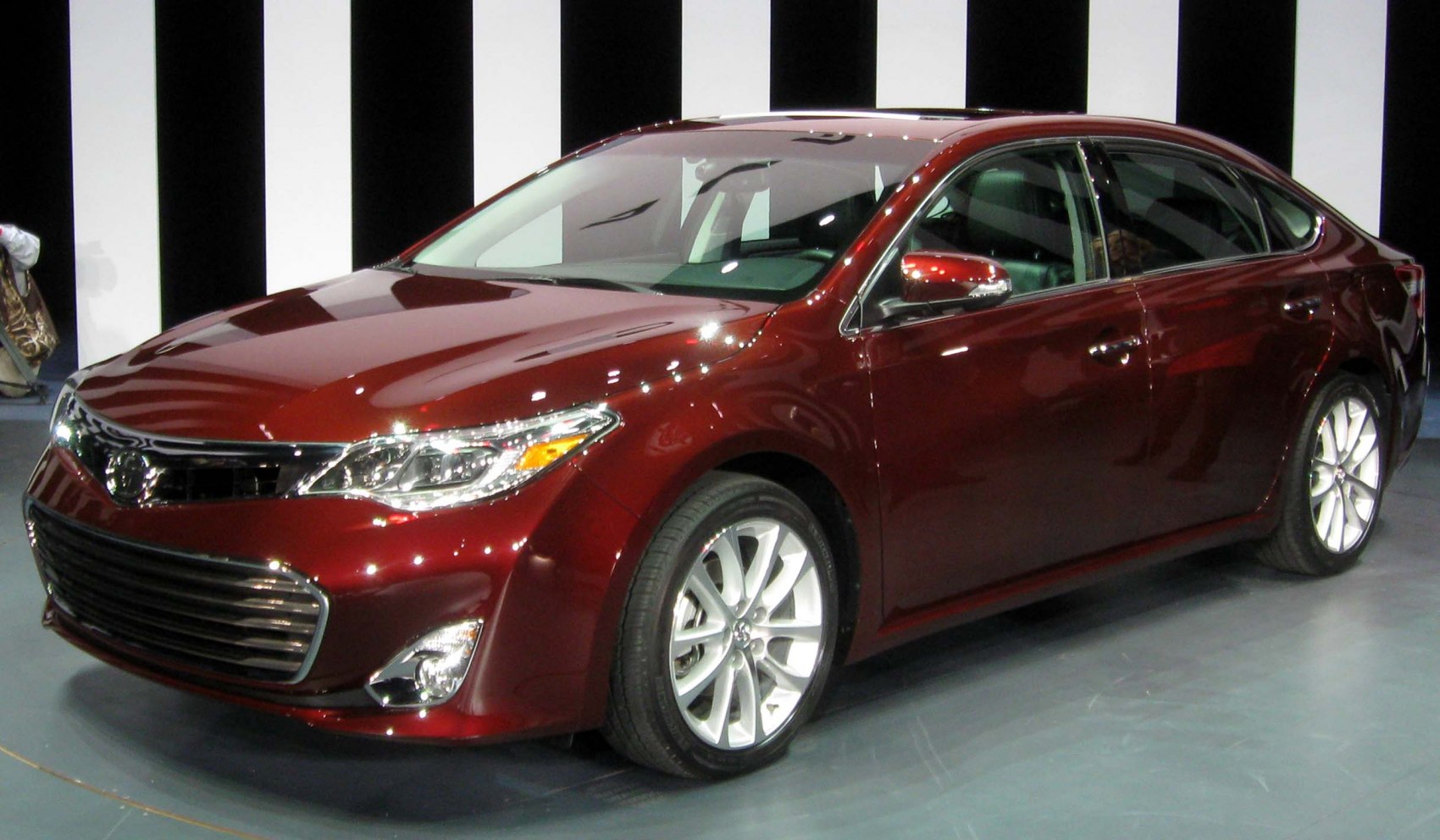 Front view of a sedan with alloy wheels and LED headlights
