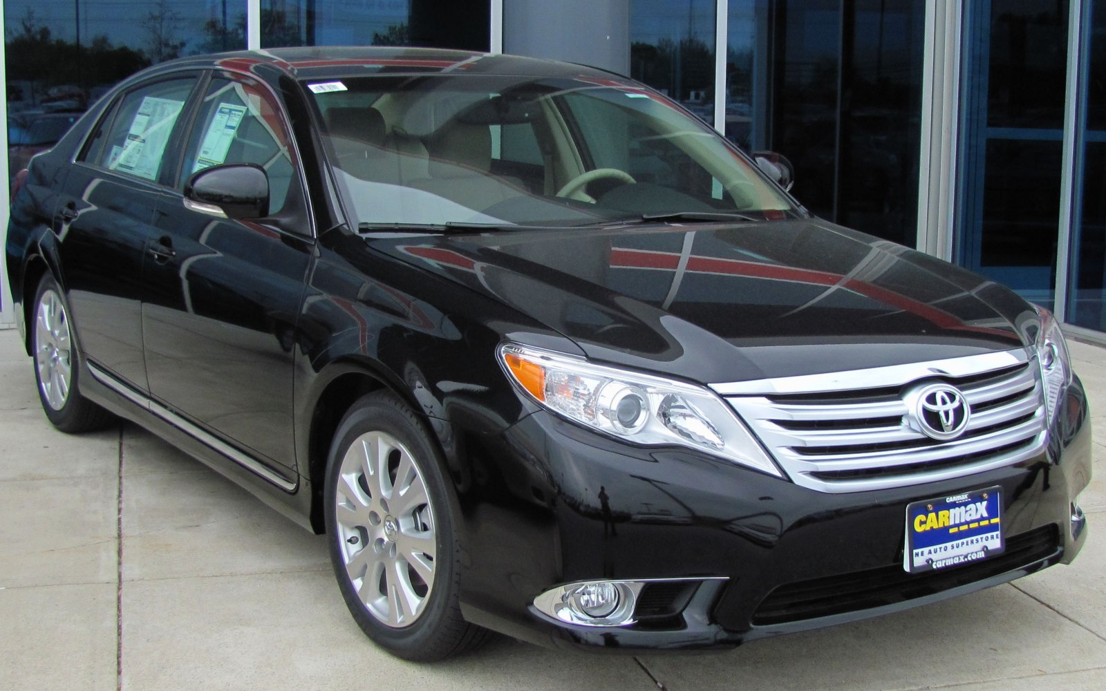 Black sedan with chrome grille, projector headlights, and fog lights