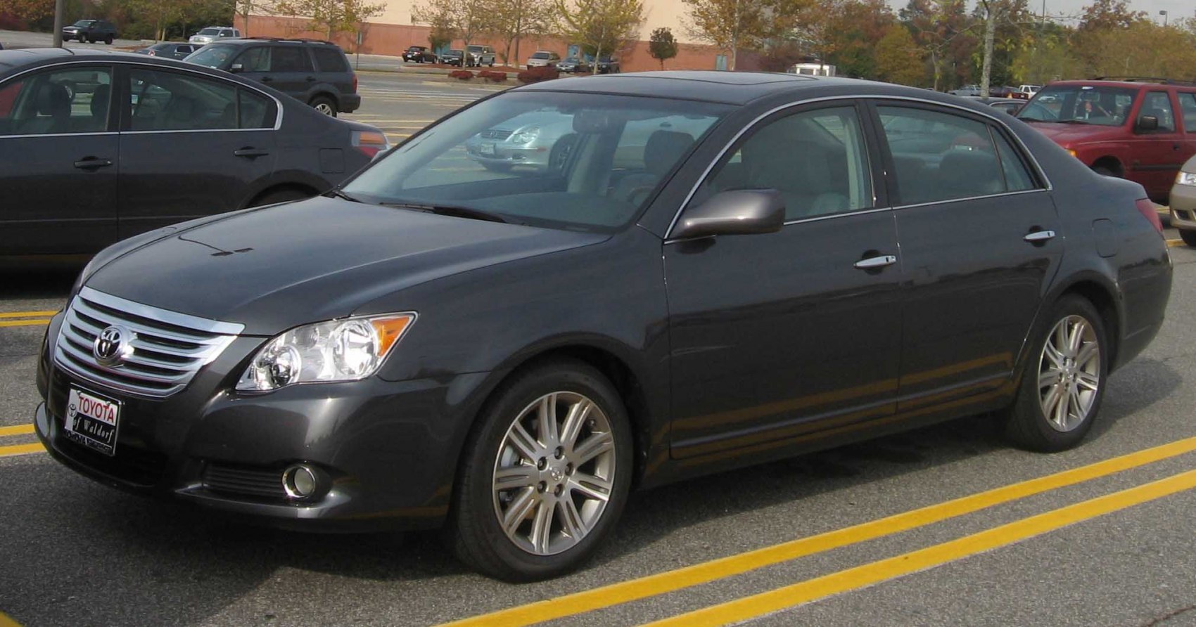 Front and side view of a dark gray sedan with alloy wheels