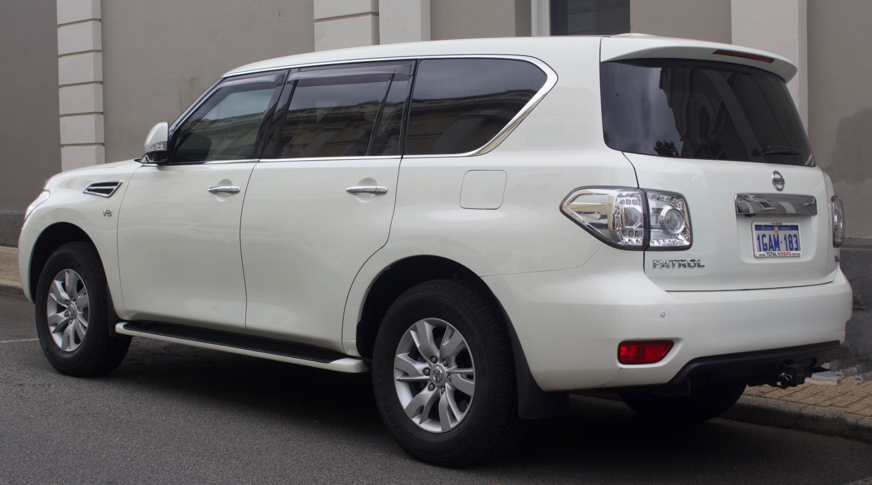 Rear side view of a large SUV with distinct tail lights and tinted windows