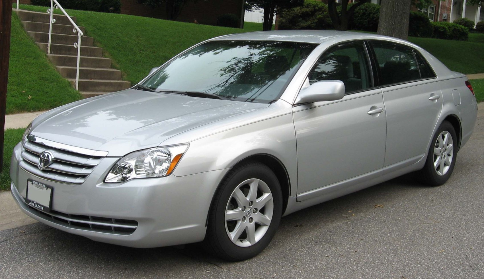 Silver sedan with alloy wheels and sleek headlights.