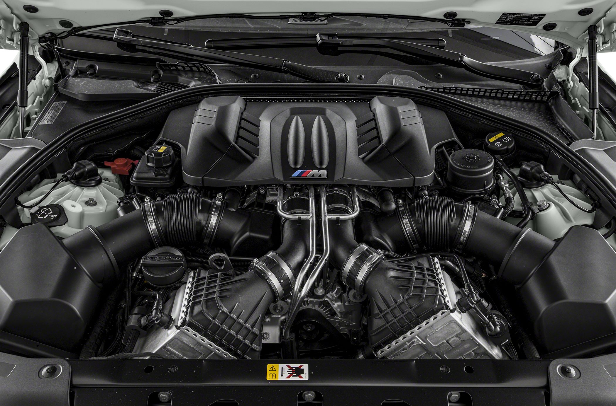 High-performance V8 engine bay with M-branded components and intake system