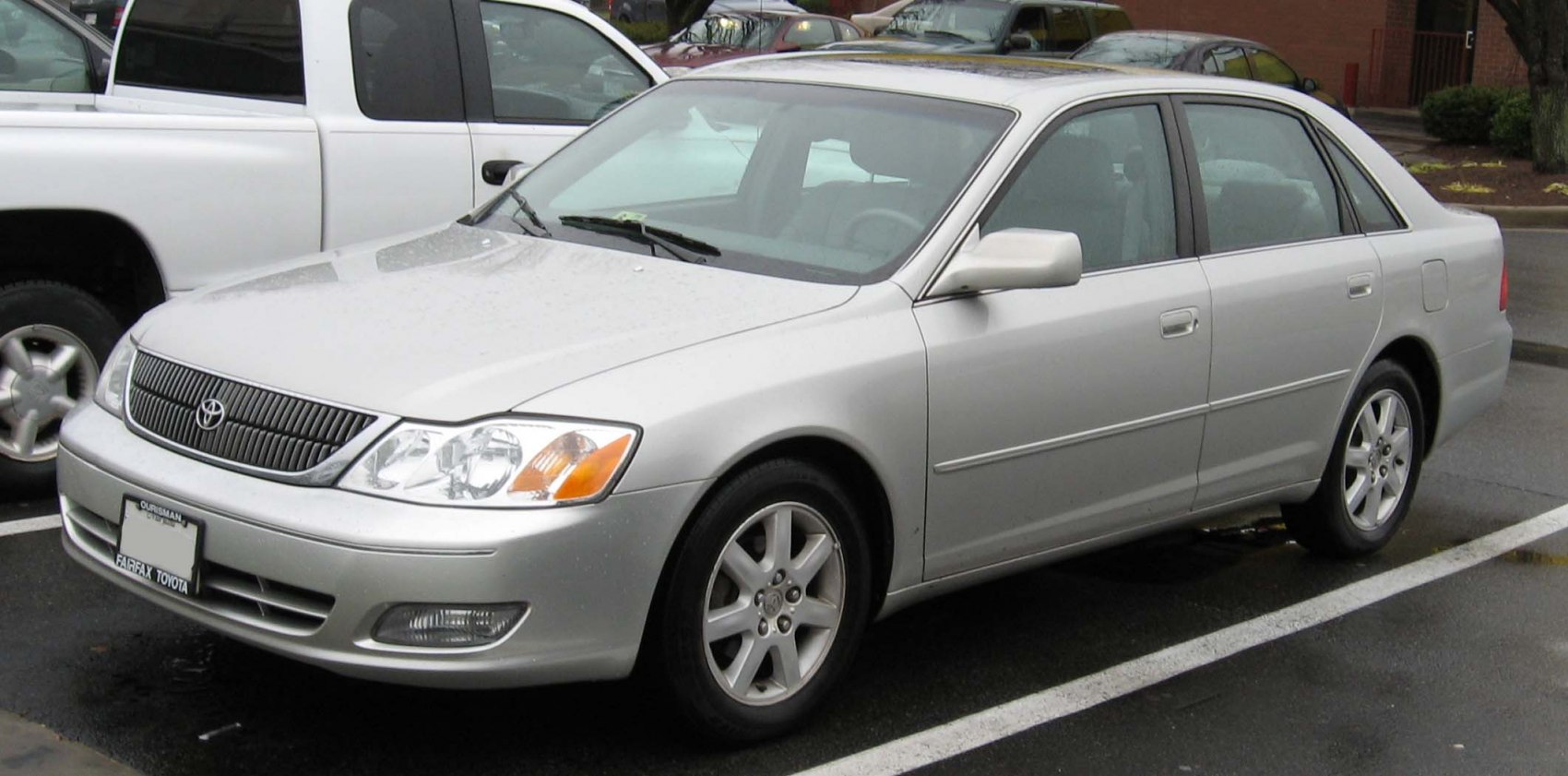 Silver mid-size sedan with classic grille and alloy wheels