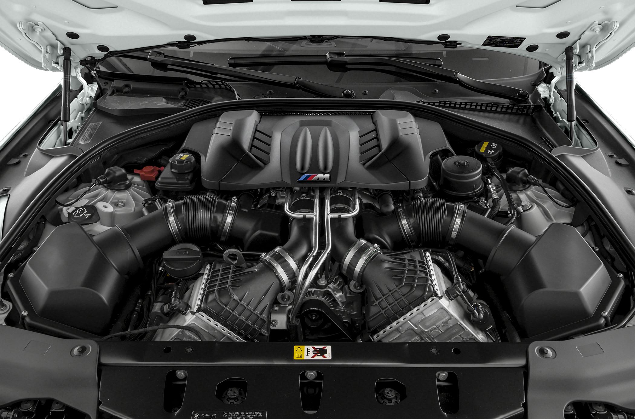 High-performance BMW engine bay with distinctive M badge cover