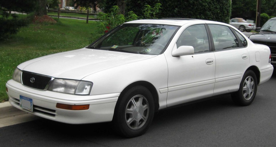 White four-door sedan showing front and side exterior