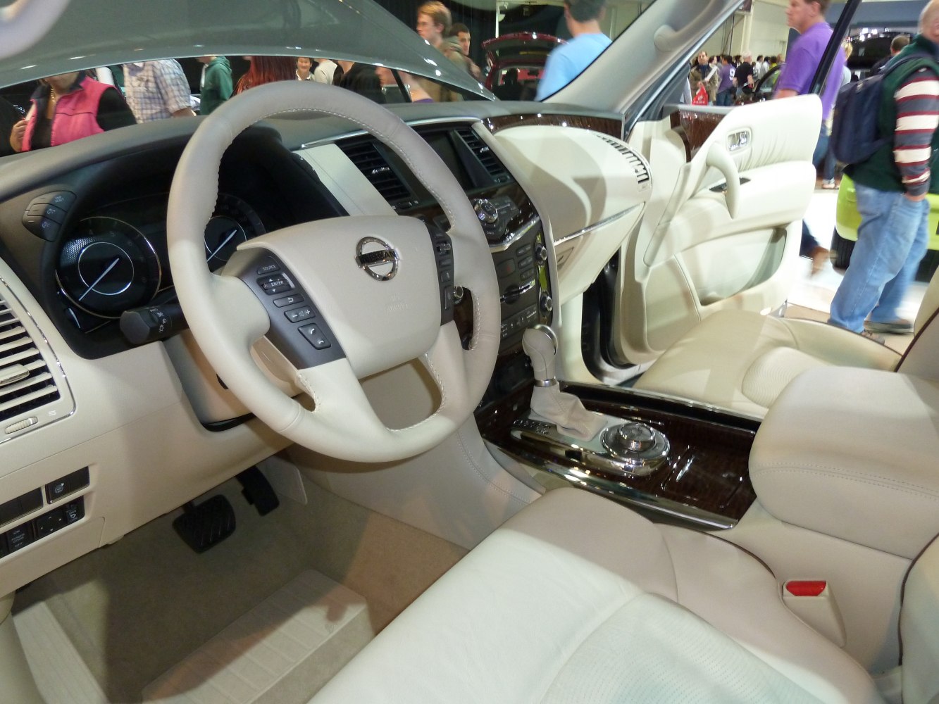 Beige steering wheel and dashboard with automatic gear shift and wood trim