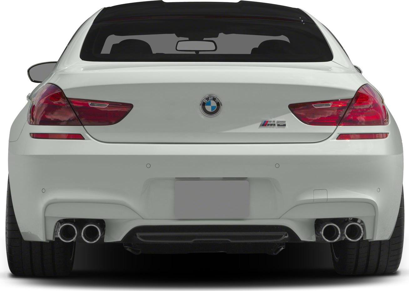 Rear view showcasing quad exhaust and sleek taillights of a luxury coupe