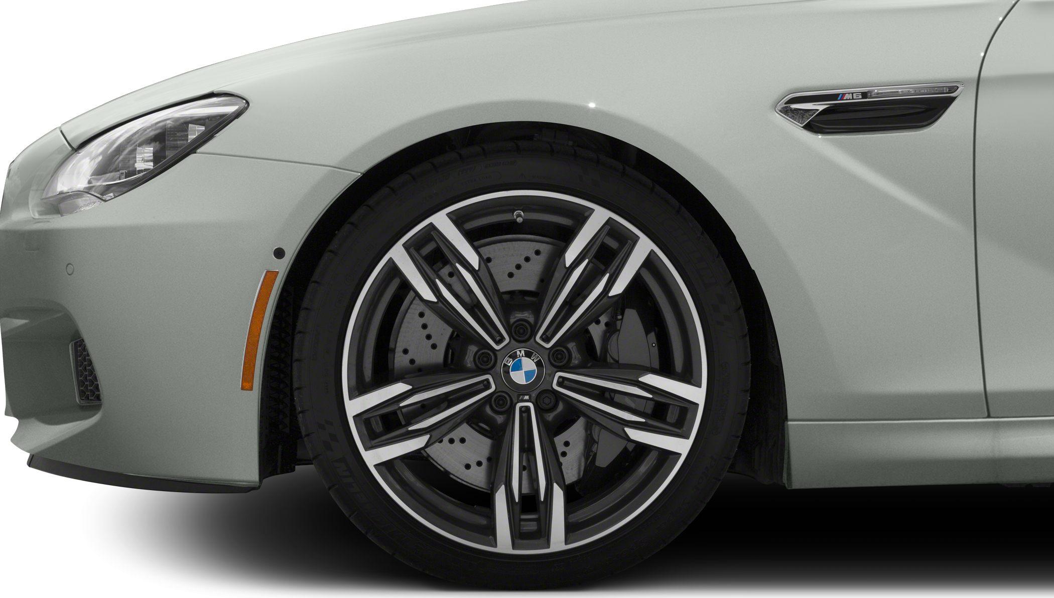 Close-up of sporty front alloy wheel and side M6 badge