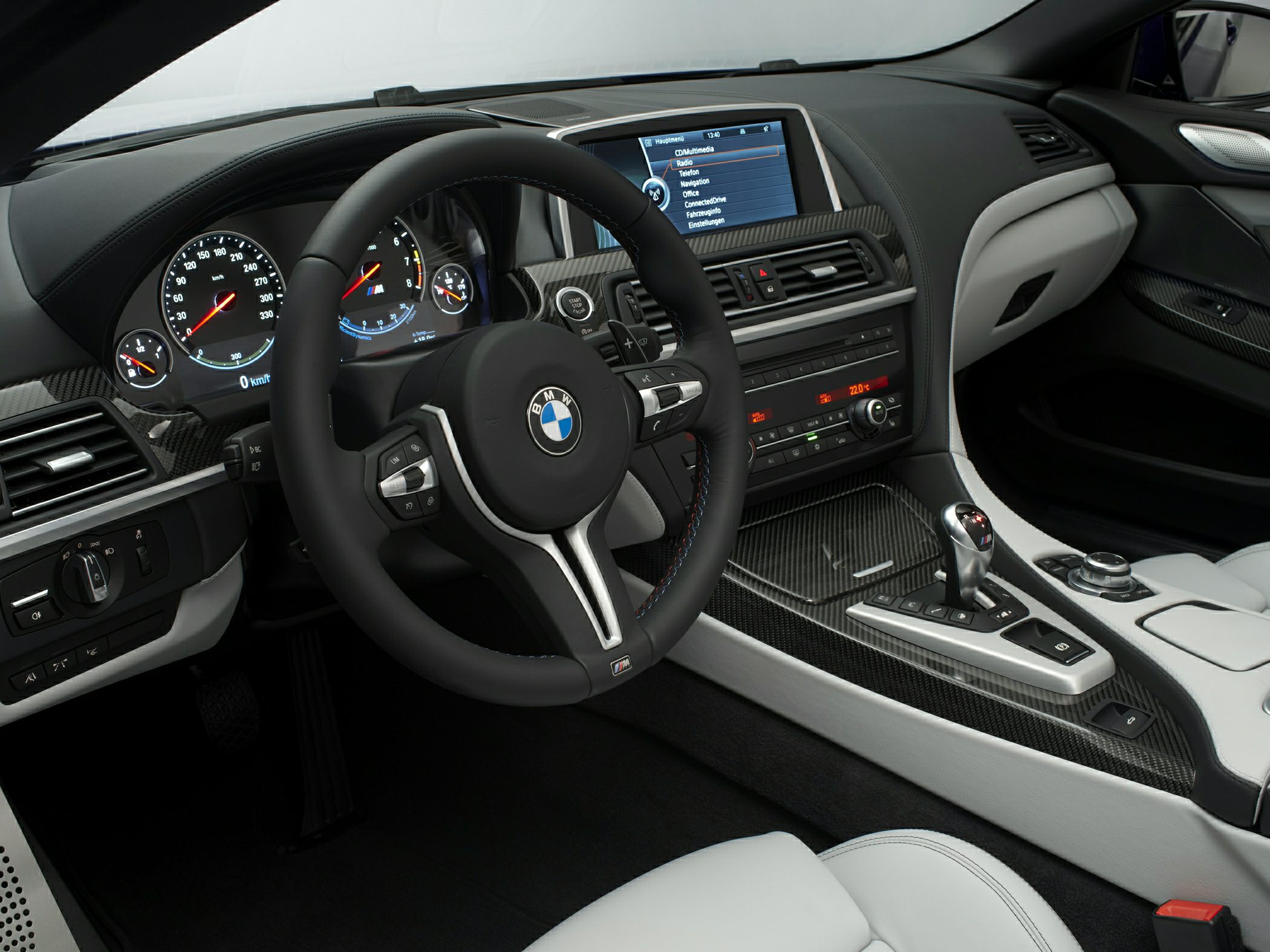 BMW interior with sport steering wheel and carbon fiber dashboard trim