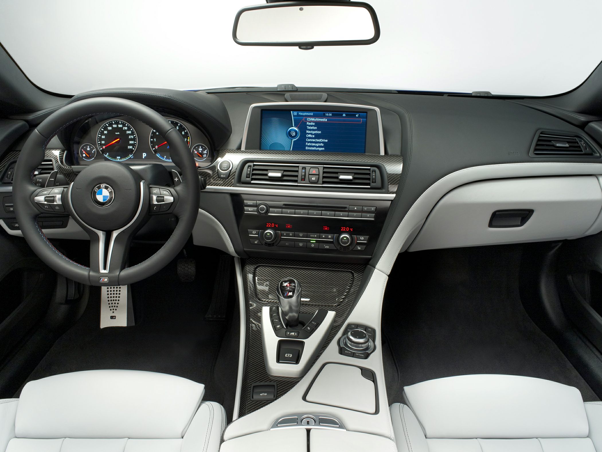 Luxury car interior with dashboard, steering wheel, and central console.