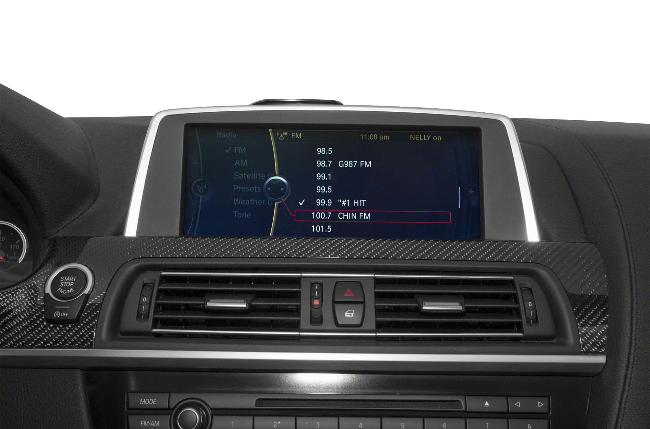 Infotainment screen with radio options and carbon fiber dashboard trim.