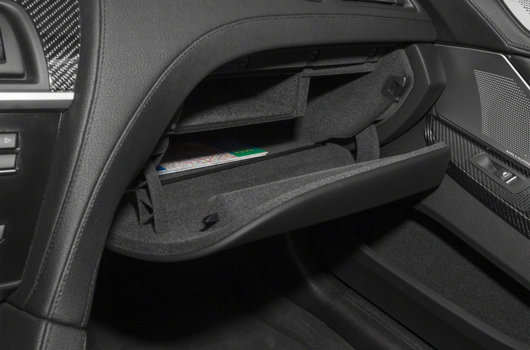 Open glove box and carbon fiber trim inside car interior