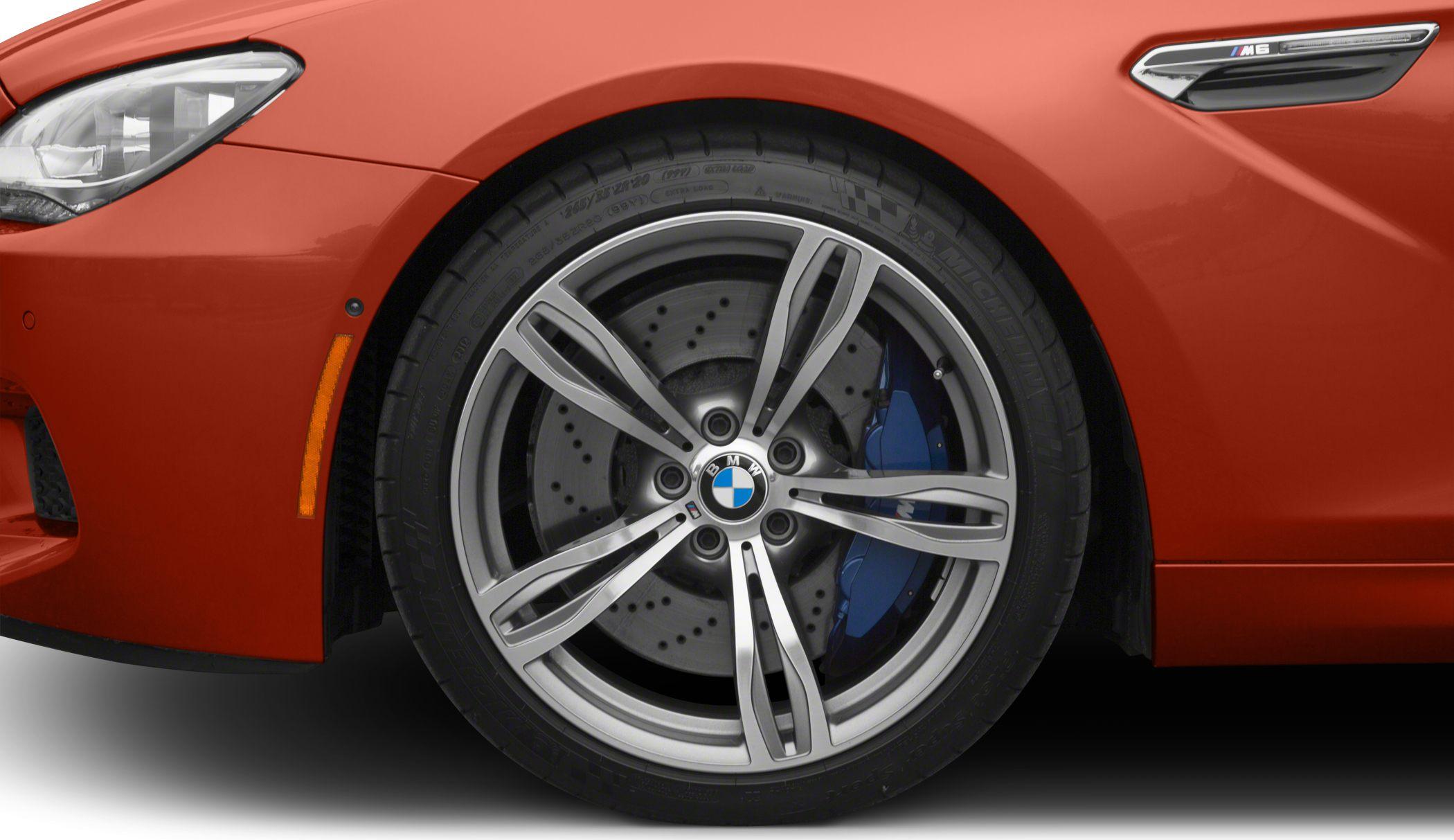 Close-up of front wheel with alloy rim and blue brake caliper