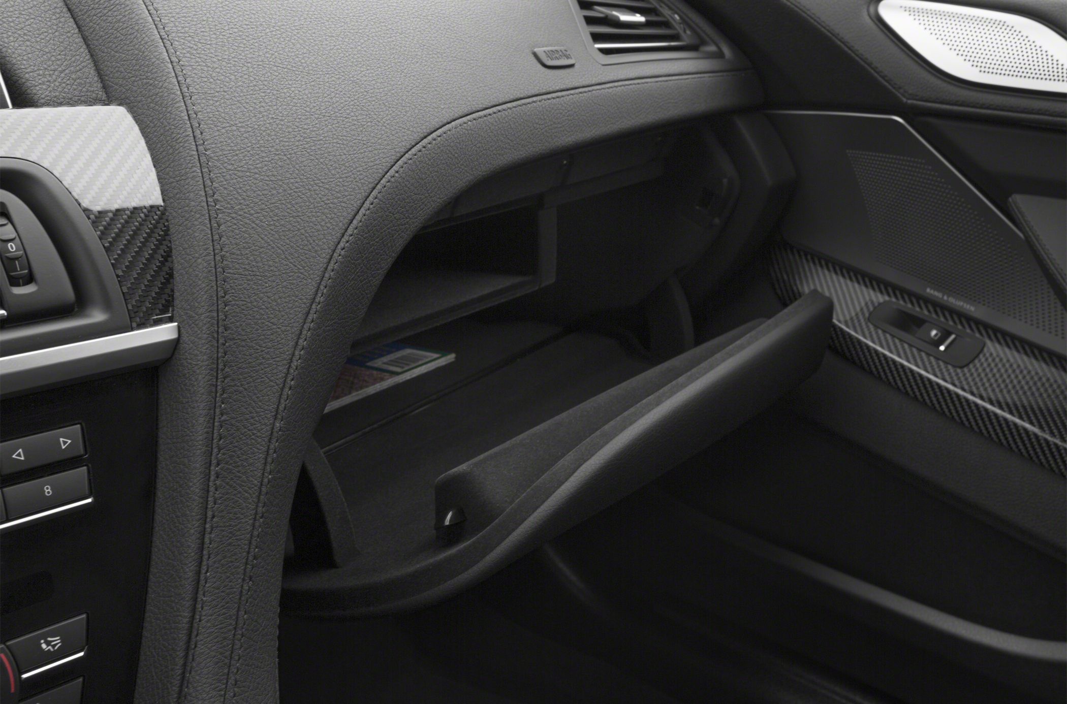 Open glovebox, carbon fiber trim, dashboard vents and controls.