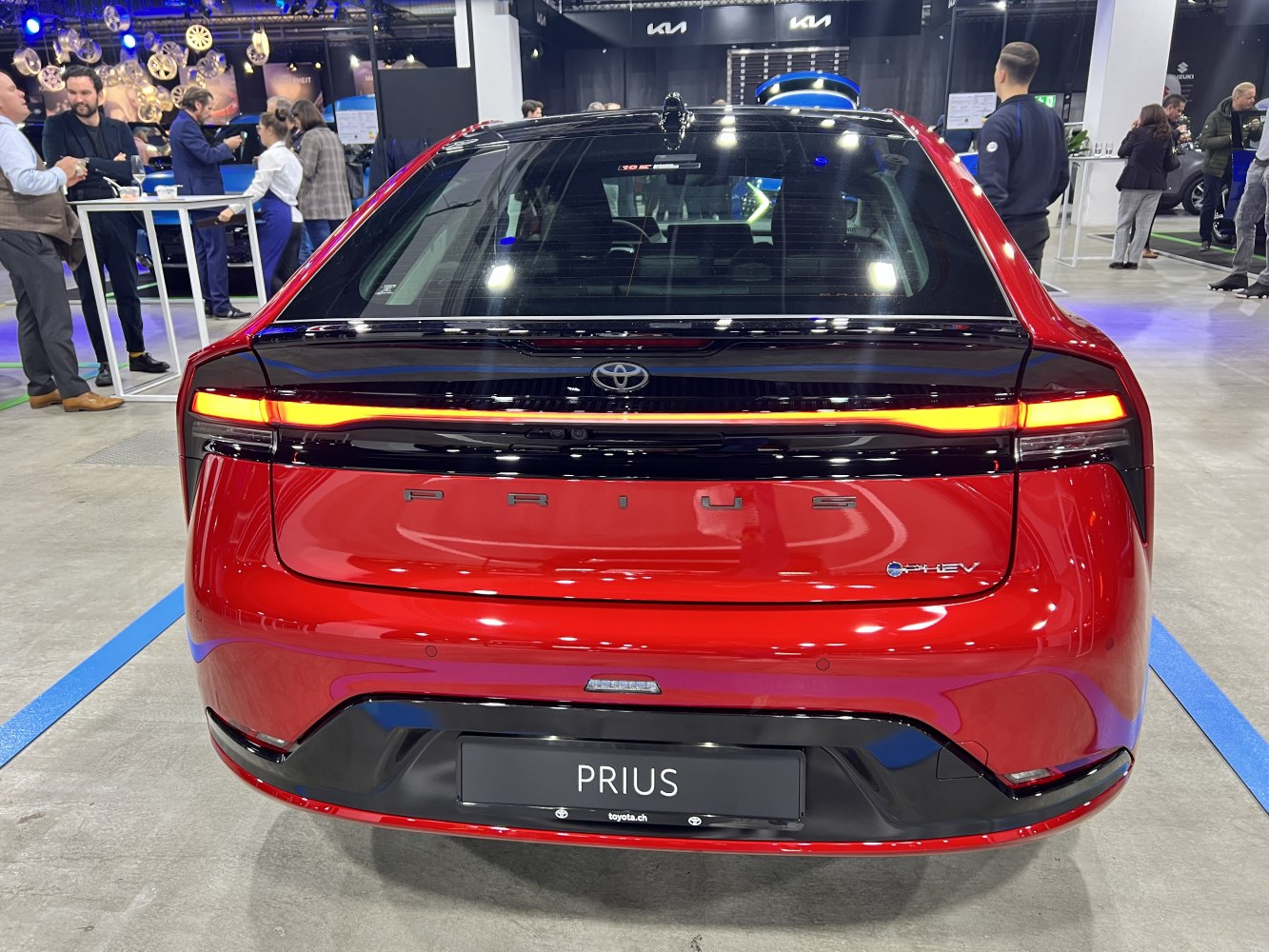 Red rear view showing continuous LED tail light and compact back design.