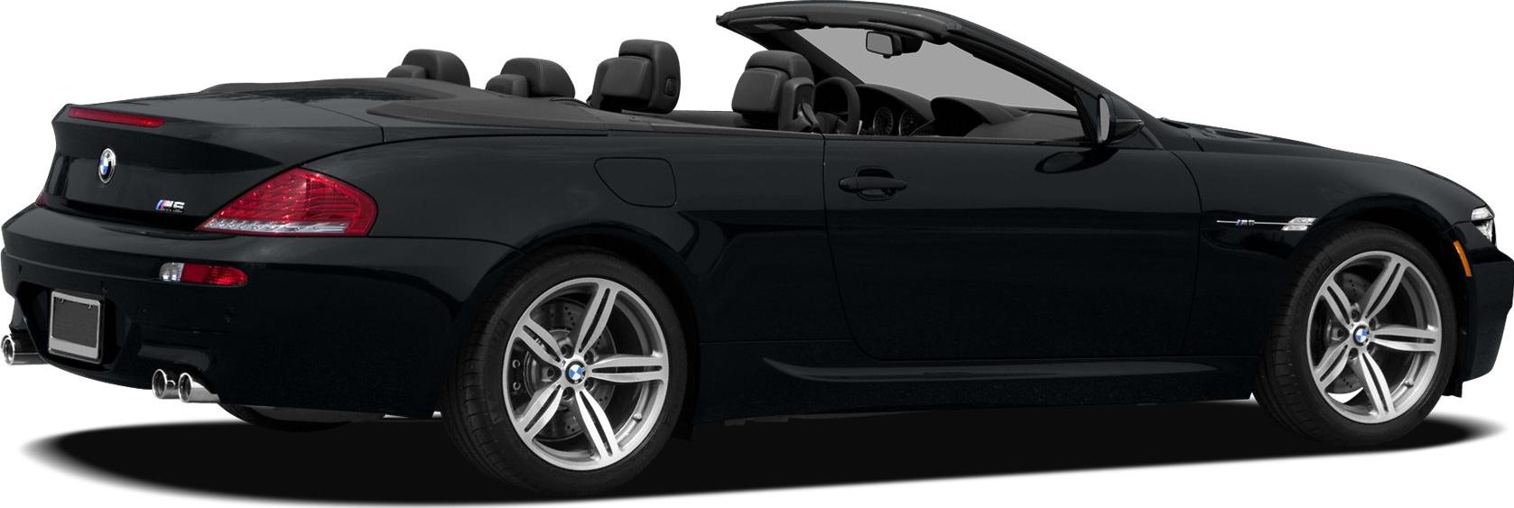 Rear side view of convertible with open roof and quad exhaust