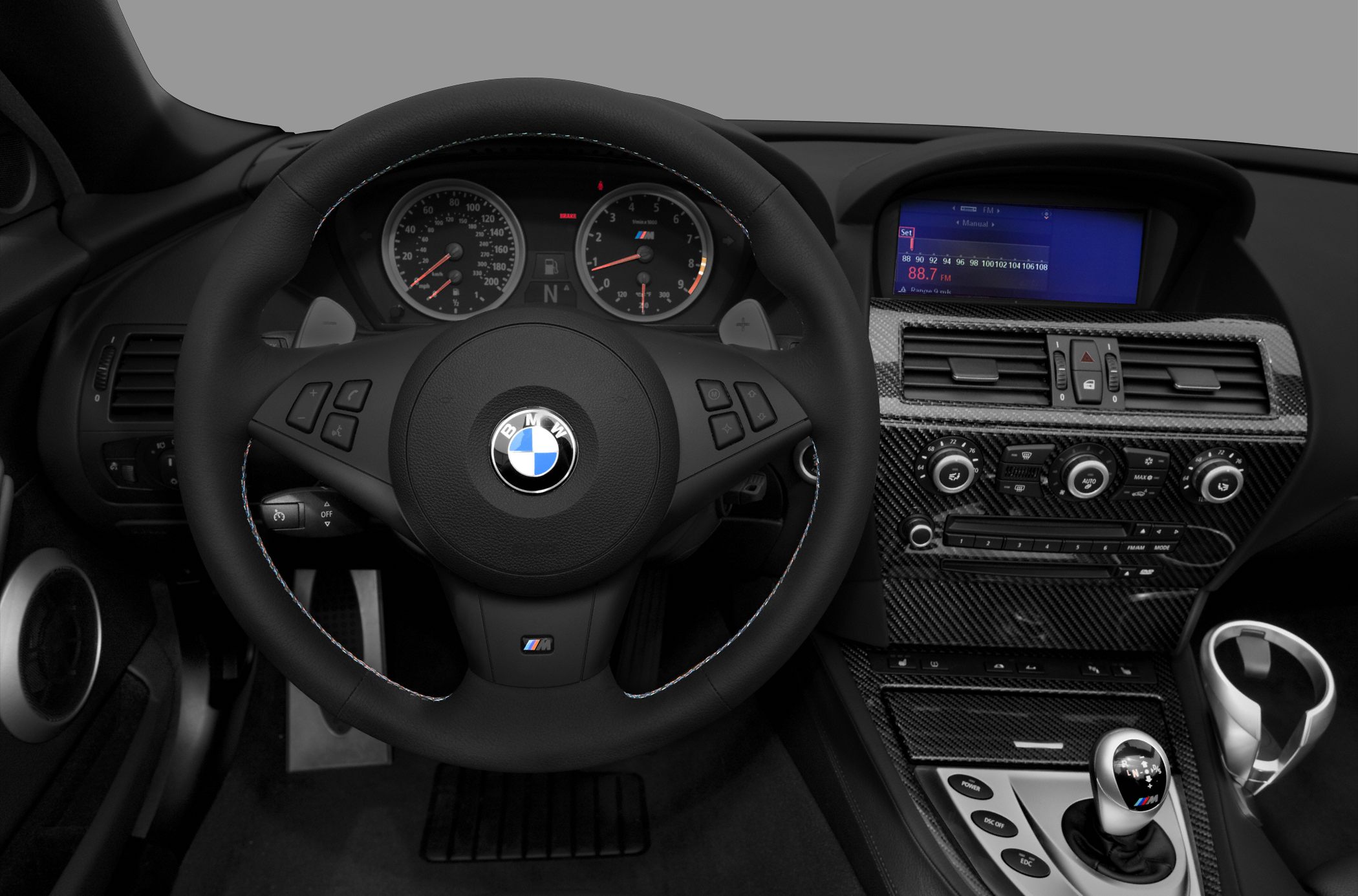 BMW convertible interior with steering wheel and carbon fiber center console