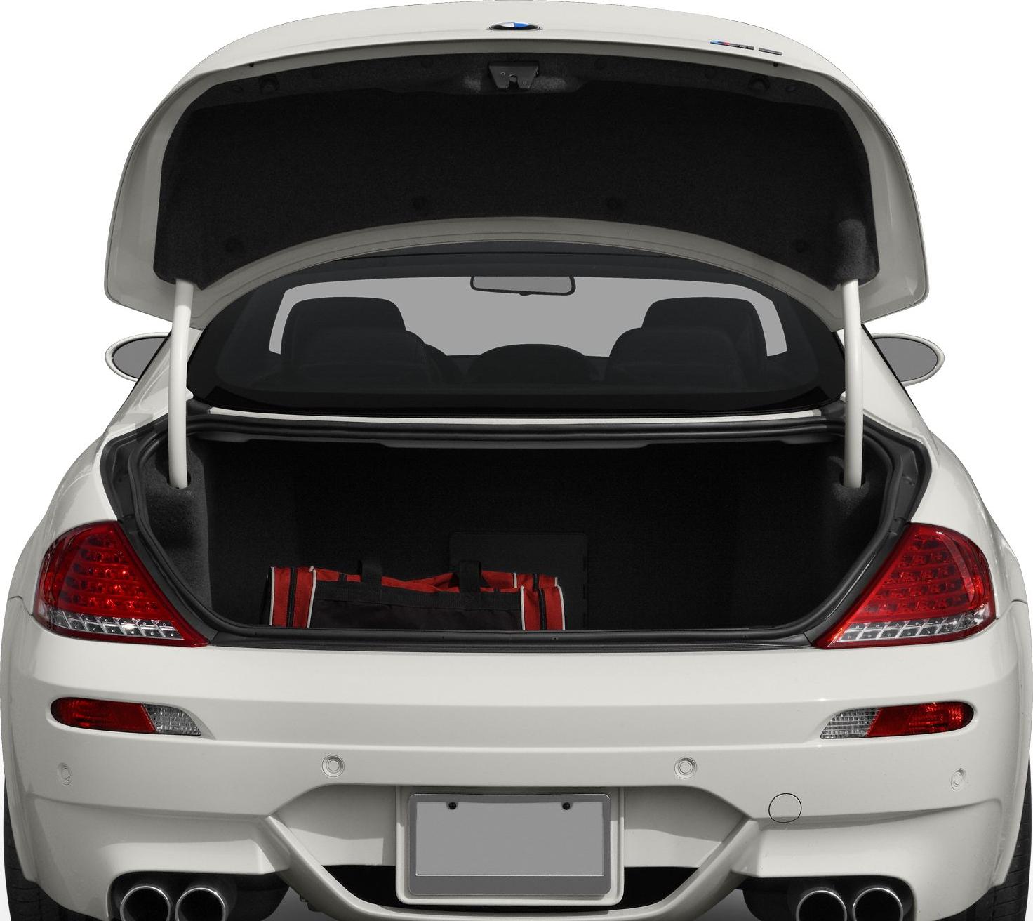 Open rear trunk with visible taillights and dual exhaust pipes