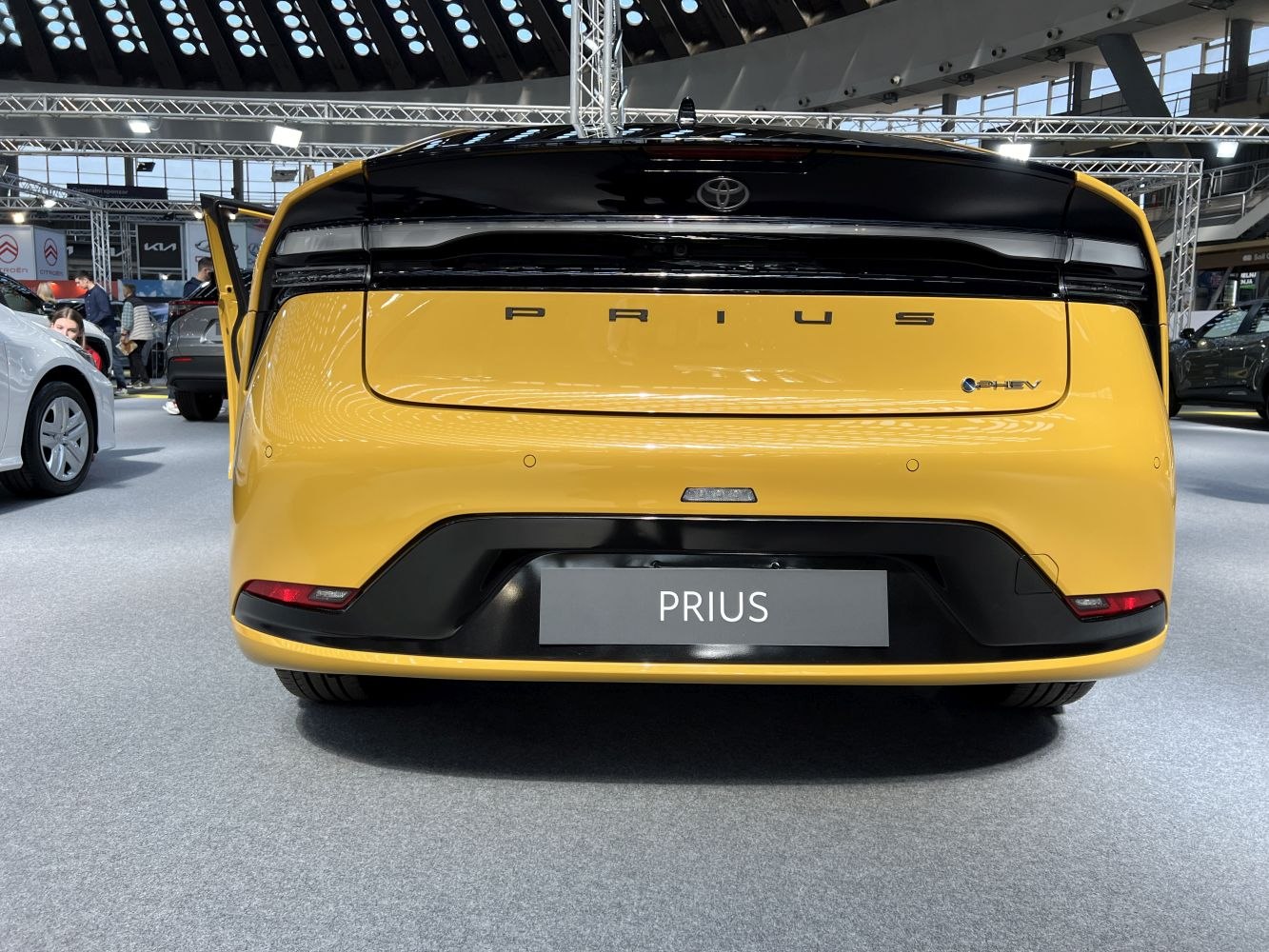 Rear view of a yellow hybrid vehicle with sleek taillights and a clean design