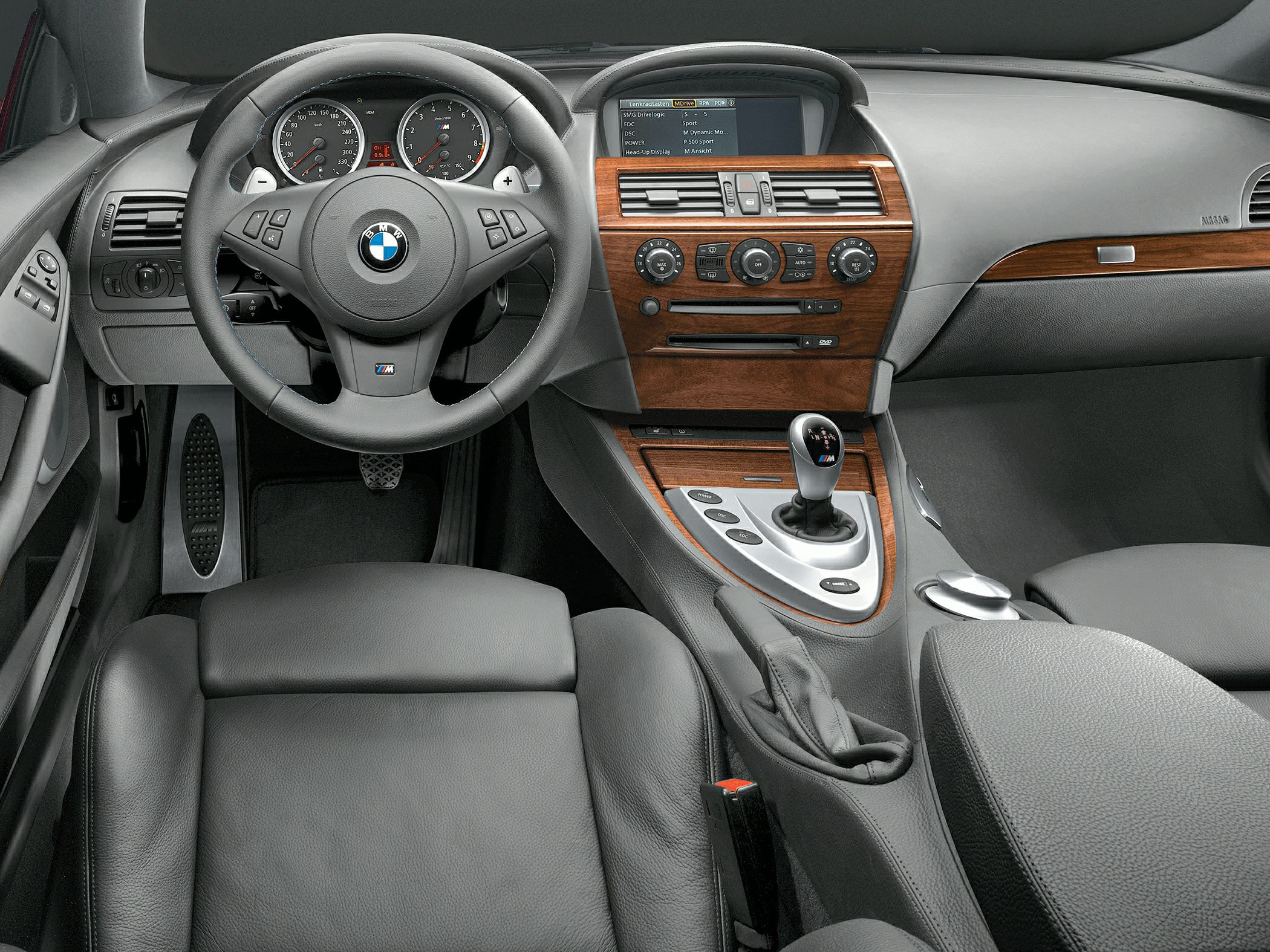 Luxury interior with wood trim dashboard and leather steering wheel