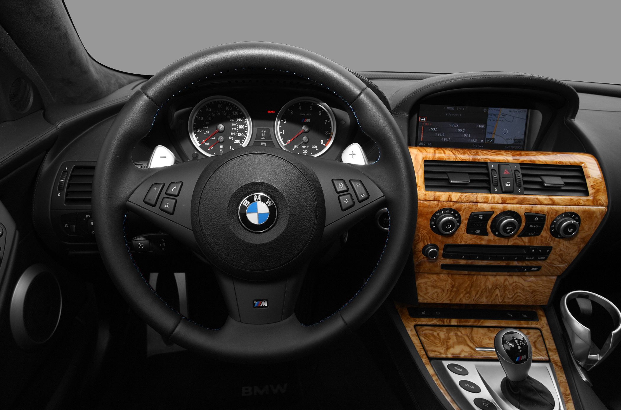 Steering wheel and wood trim dashboard with gear shifter
