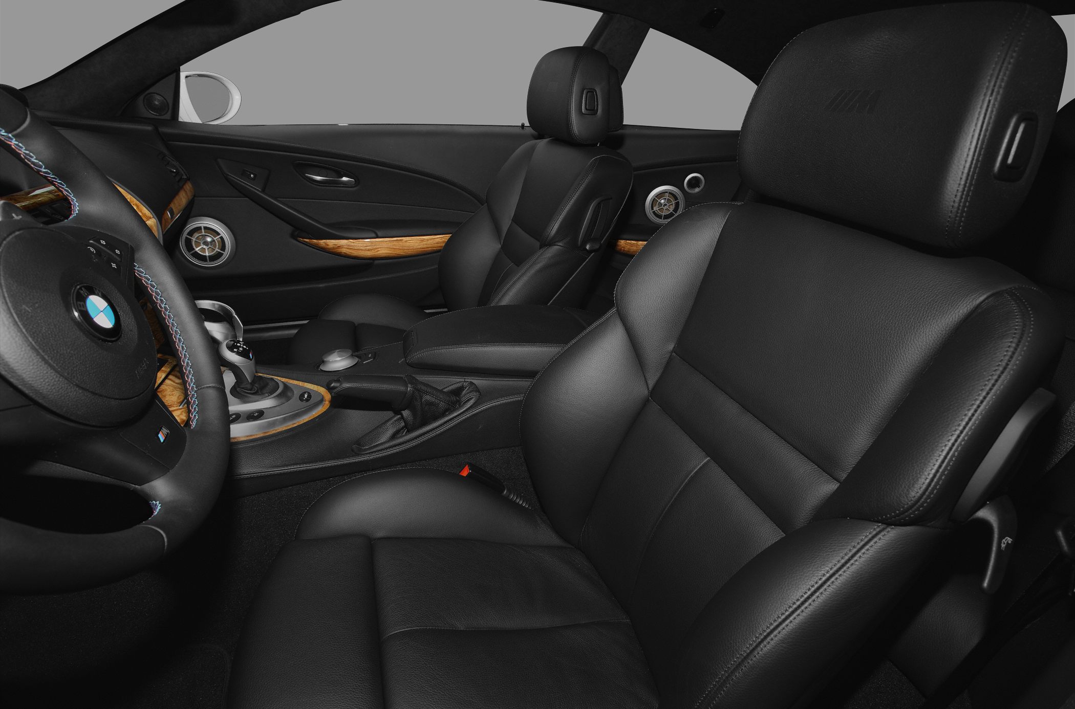 Black leather seats with wood trim and detailed steering wheel