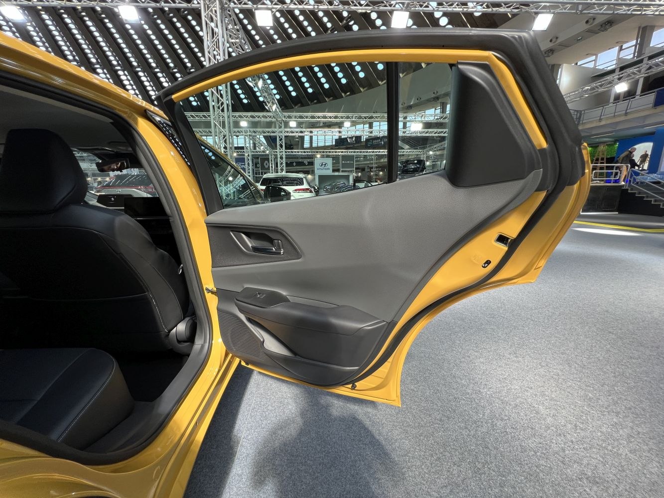 Rear door interior panel with armrest and window controls