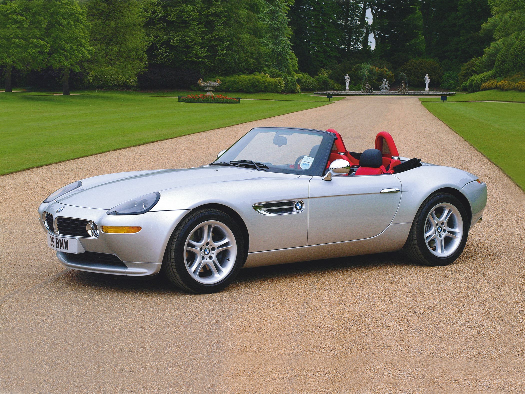 Silver convertible, red seats, chrome side mirrors, sporty roadster design