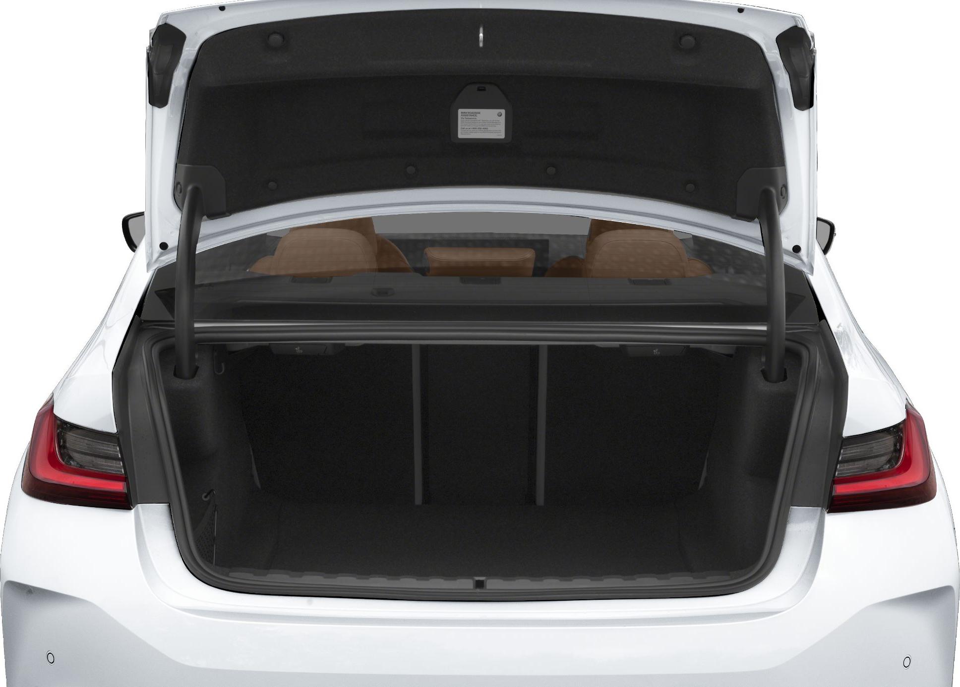 Open spacious trunk with visible brown leather rear seats