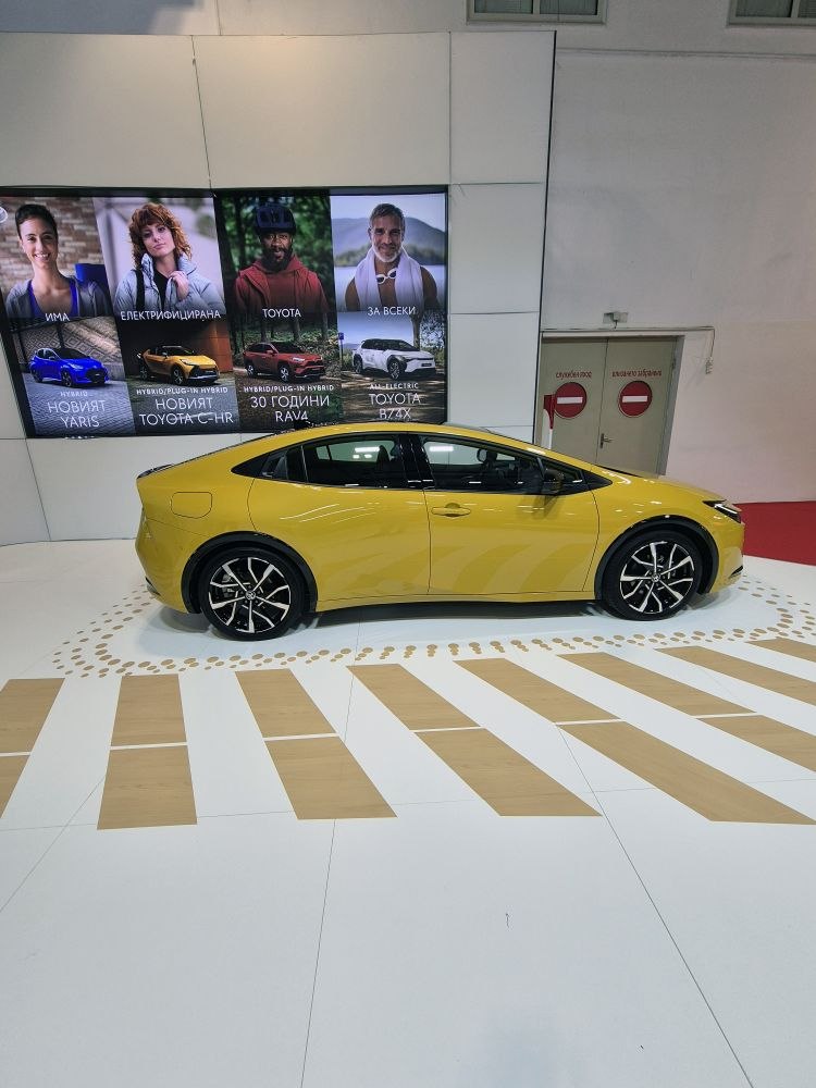 Yellow hybrid hatchback with sleek side profile and sporty alloy wheels