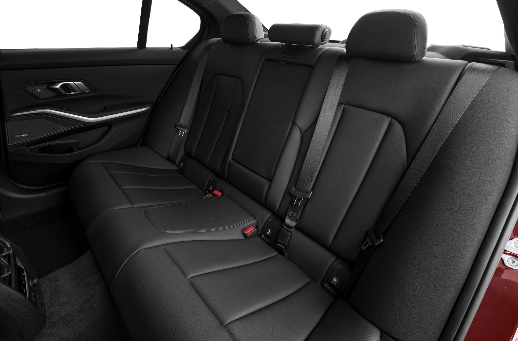 Rear leather seats with headrests and seat belts in a luxury sedan