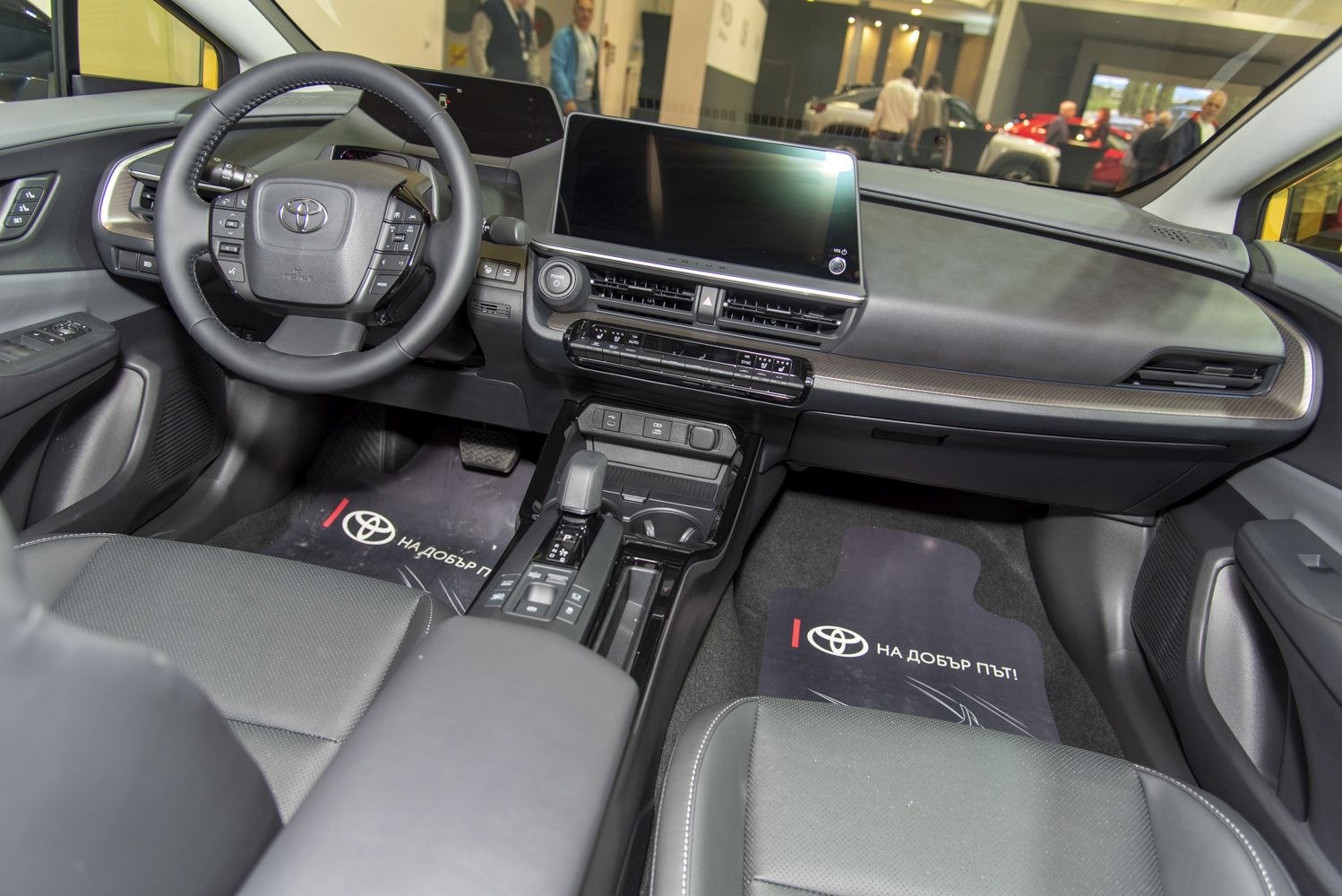 Large touchscreen and multifunction steering wheel in a modern car interior